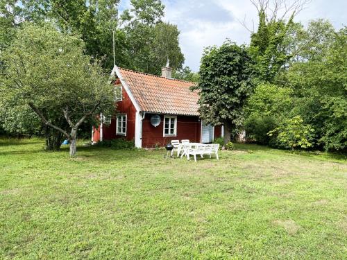 Red small cottage on Oland surrounded by grazing sheep